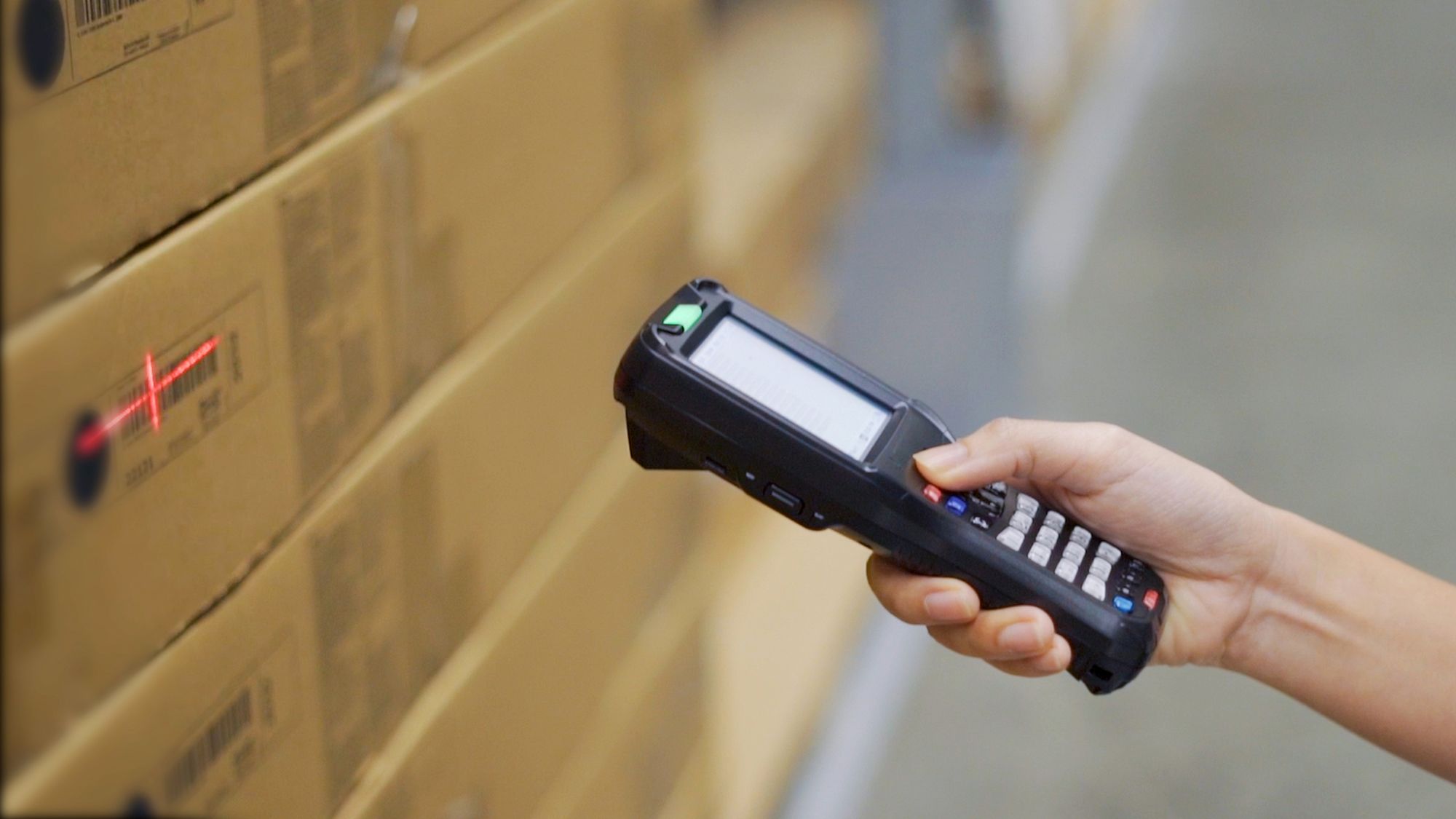 Worker using a barcode scanner on product