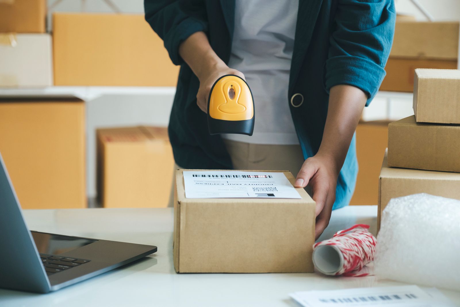 A young entrepreneur scanning online order boxes