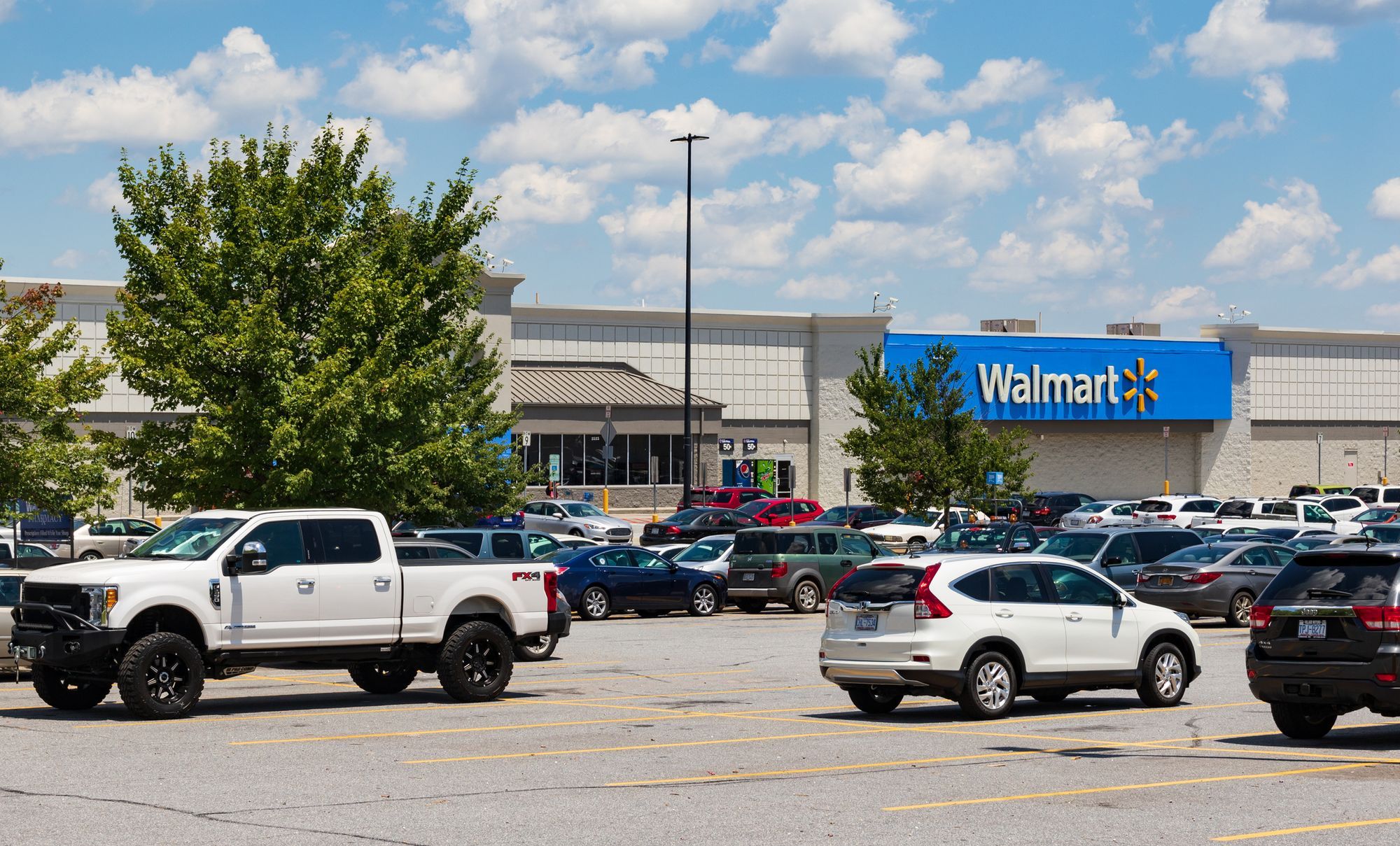 Vehicles parked at a Walmart parking lot.