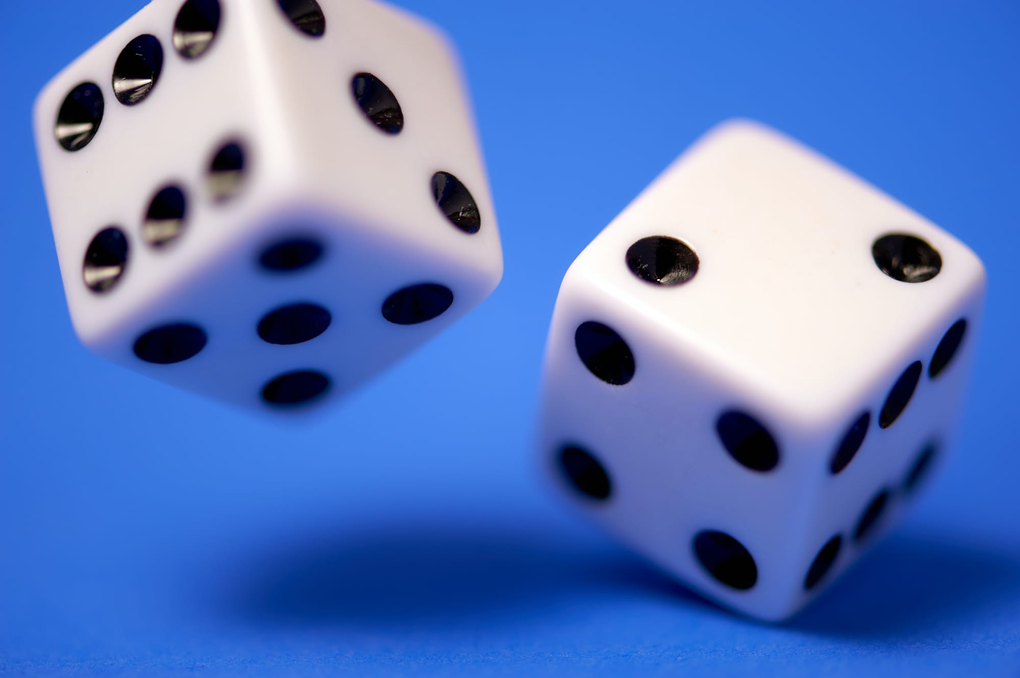 Two dices on a blue background.