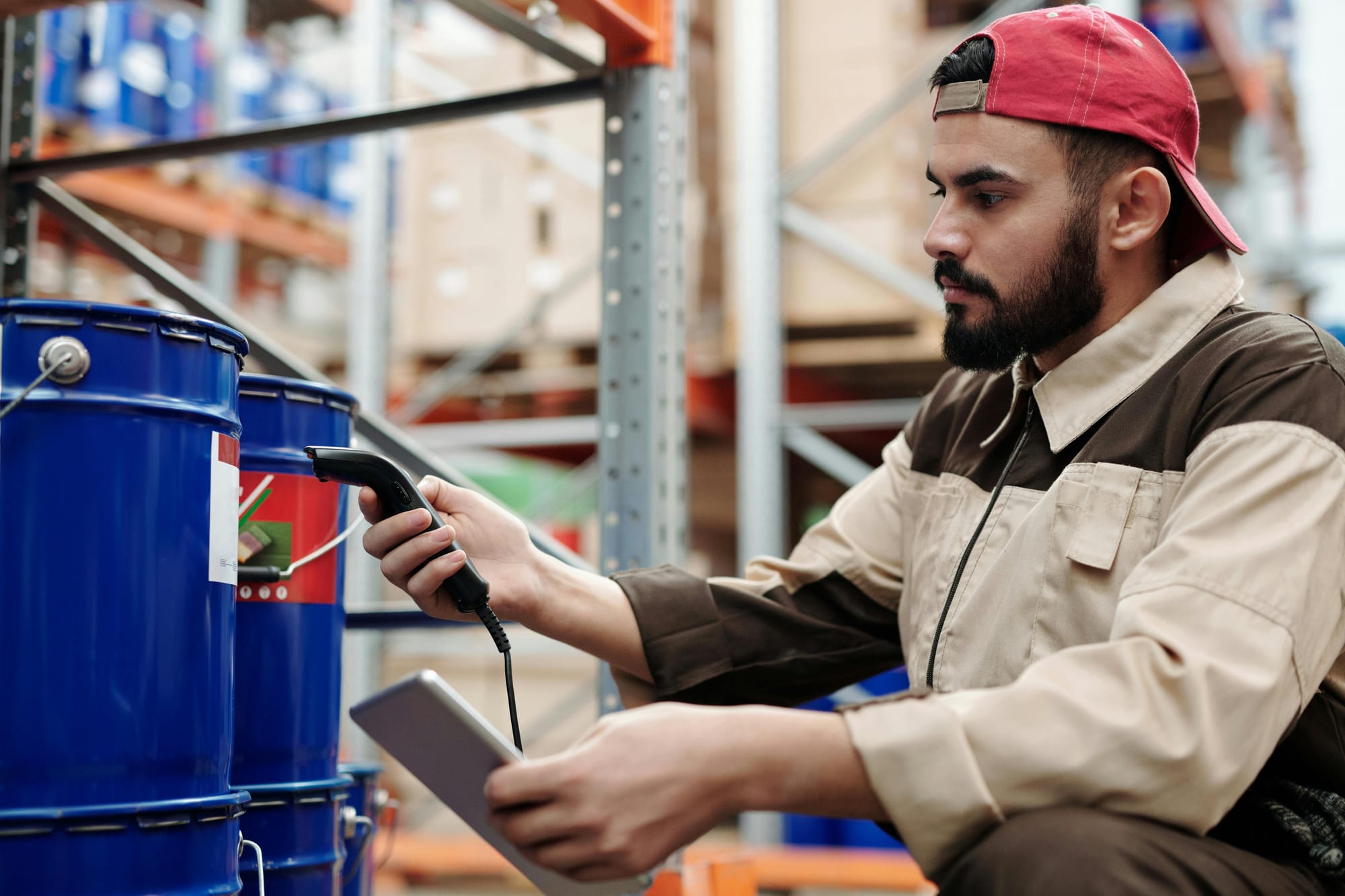 Warehouse staff scanning product with barcode scanner