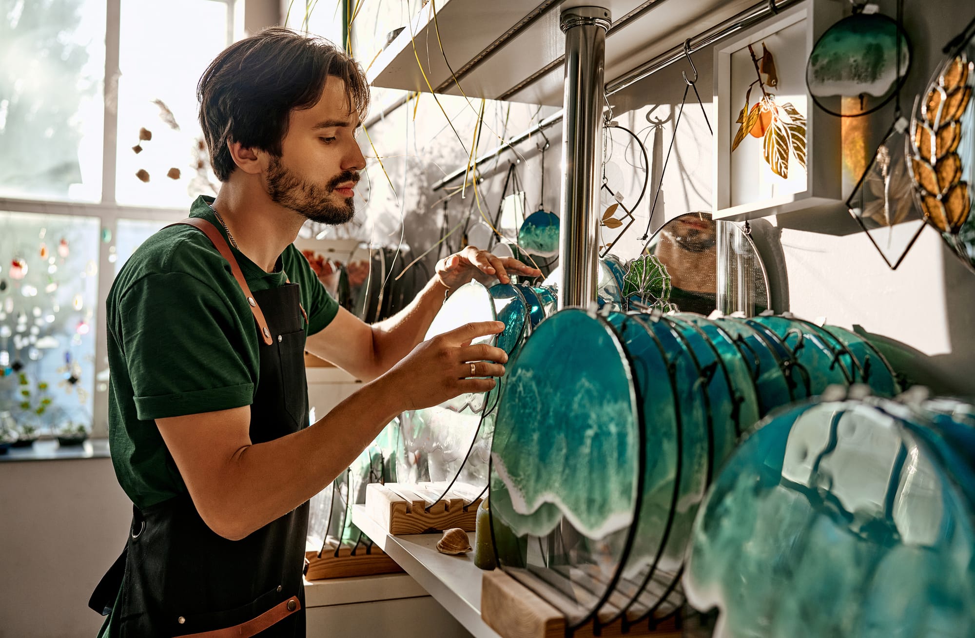 Small business owner of a home decor store moving products on shelf