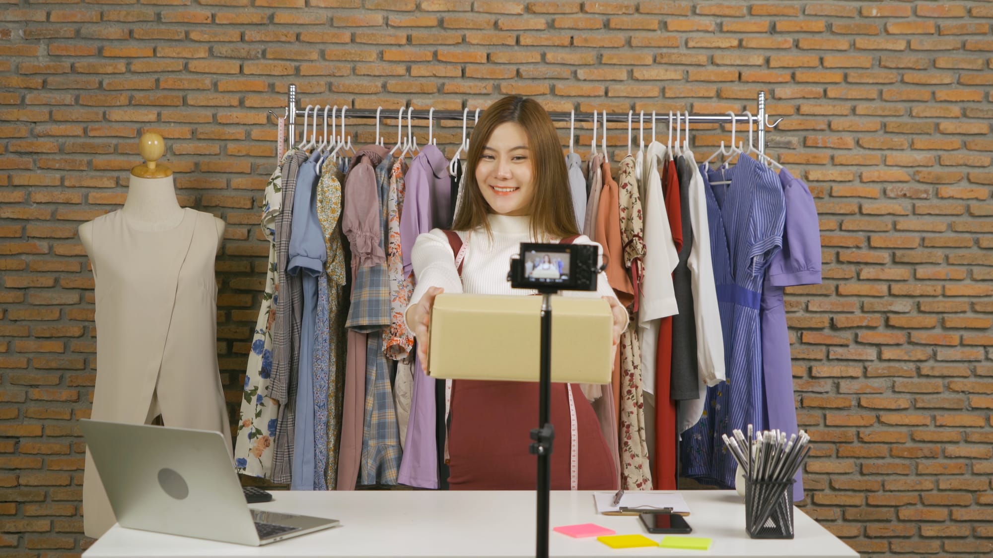 A business owner recording a video to showcase her curated items for a social commerce content.