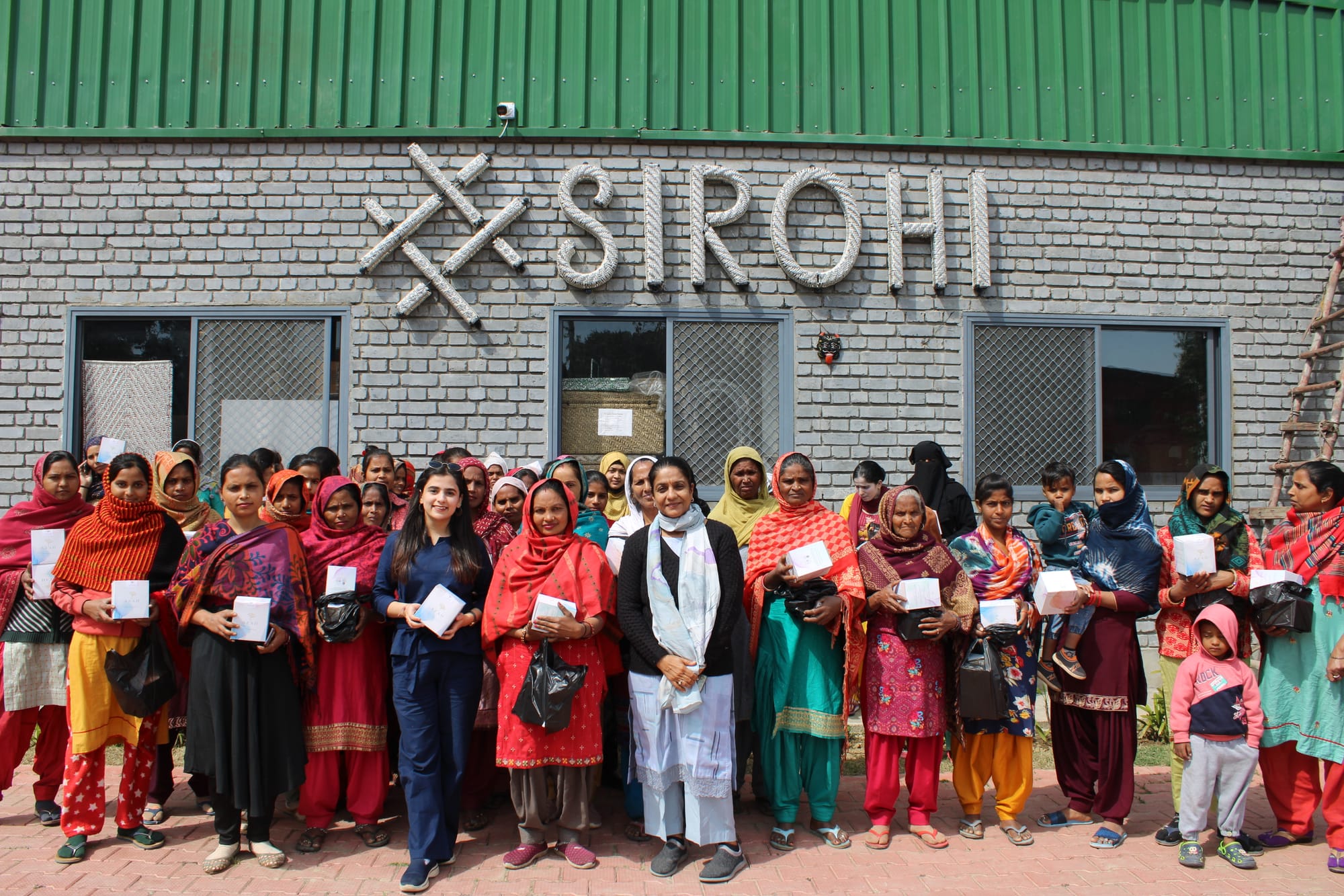 Women artisans and the Sirohi team gathered in front of their headquarters, highlighting their commitment to craftsmanship and empowerment.