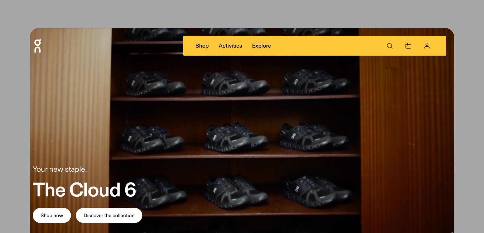 On Running’s website featuring The Cloud 6 shoes, displayed in a wooden shoe rack, with a bold yellow navigation bar.