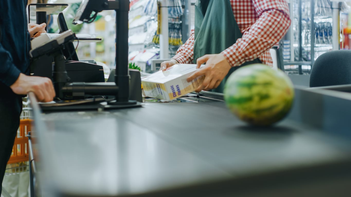 At the Supermarket: Checkout Counter Hands of the Cashier Scans Groceries, Fruits and other Healthy Food Items.