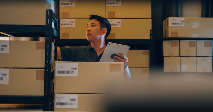 An inventory manager checking quantities of inventories in a warehouse