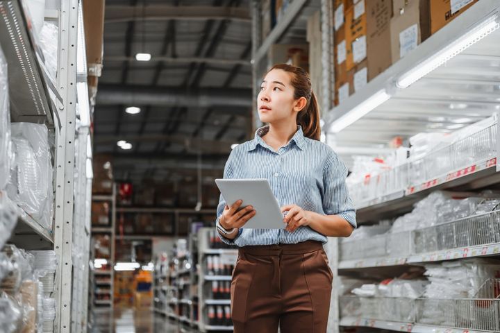 A female employee checking inventory in a warehouse