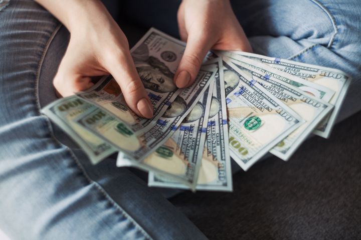 Girl holding American Dollar Bills.