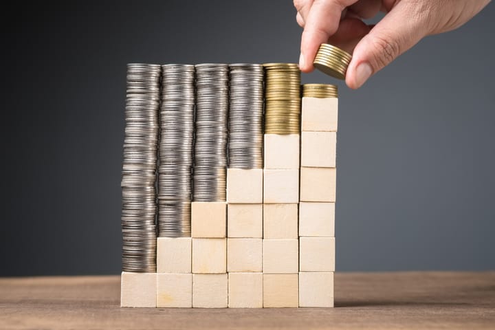 Hand arrange the heaps of coins onto the step wood cubes and fill a few coins at the last step.