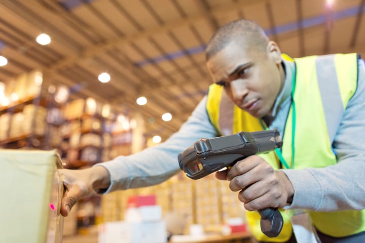 Warehouse staff scanning boxers with barcode scanner